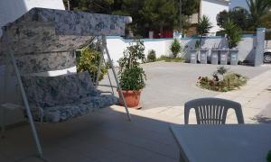 a chair and a couch sitting on a patio at B&B Trullo Di Mare 2 in Marina di Lizzano