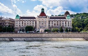 a large building with a clock tower on top of it at Danubius Hotel Gellért in Budapest