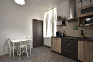 a kitchen with a table and a table and chairs at TopApartmany Lesni in Mariánské Lázně