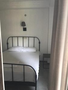 a bedroom with a bed with a lamp on the wall at GONIO Mgzavrebi III Apartment 403 in Gonio +6 photos