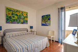 a bedroom with a bed and a table and a window at Terrazza Marina in Porto Santo Stefano +39 photos