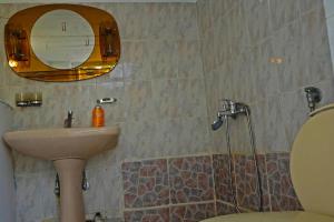 a bathroom with a sink and a mirror at Villa Fofo - Beautiful Sea Front Villa with 650m2 garden in Nea Kalikratia +33 photos