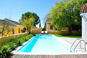 a swimming pool in the backyard of a house at Quinta Da Cabrita in Santarém