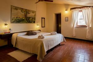 a bedroom with a bed with two stuffed animals on it at Agriturismo Bio Le Macchie Alte in Manciano