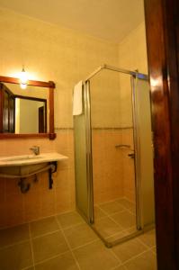 a bathroom with a shower and a sink at Olive Garden Apart Hotel in Göcek