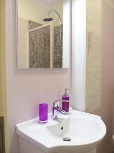 a white bathroom with a sink and a mirror at La Dorata in Trieste