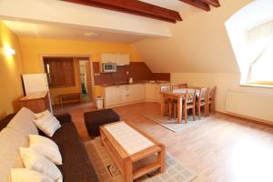 a living room with a couch and a table at Central Apartmany in Smokovce +34 photos