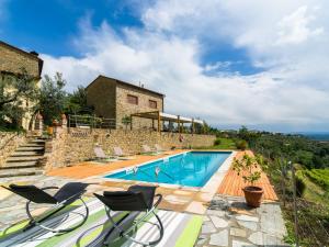 a villa with a swimming pool and a building at Exotic Holiday Home in Vinci with Swimming Pool in Vitolini