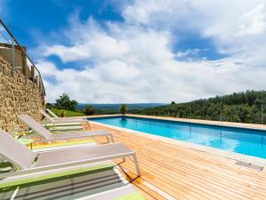 a swimming pool with lounge chairs on a wooden deck at Exotic Holiday Home in Vinci with Swimming Pool in Vitolini
