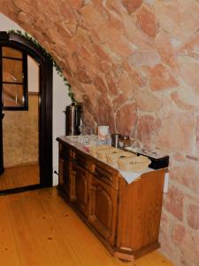a kitchen with a counter and a stone wall at Willa Rycerz in Niedzica Zamek