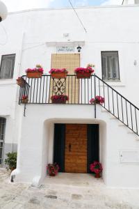 a white building with a door and flower boxes at Antico Rifugio in Carovigno