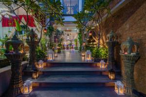 a hallway with stairs in a building with lights at Cambana Residence in Siem Reap