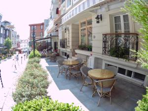 a patio with tables and chairs outside of a building at Hotel Novano in Istanbul