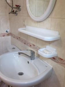 a bathroom with a sink and a mirror at Дом семейного отдыха in Karolino-Buhaz +15 photos