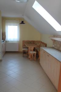 a kitchen with a sink and a table and a window at Holiday house EWA in Meszna Opacka