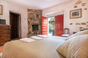 a bedroom with a large bed and a fireplace at B&B Vecchia Fonte in Campiglia Marittima