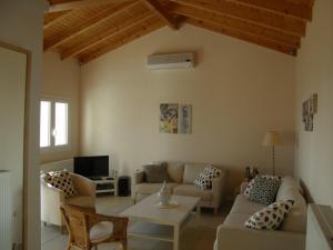 a living room with a couch and a table at Villa Daphne in Pelekas