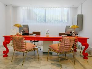 an office with a red desk and two chairs at Topazio Vibe Beach Hotel & Apartments - Adults Friendly in Albufeira
