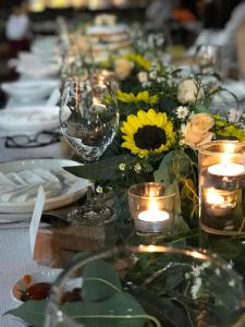a long table with candles and flowers on it at Sao Khue Riverside Hotel & Coffee in Sa Ðéc
