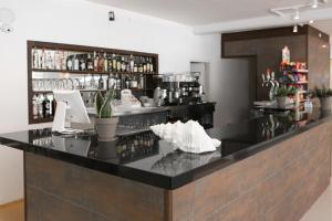 a bar in a room with a counter with alcohol at RVHotels Nieves Mar in L'Escala