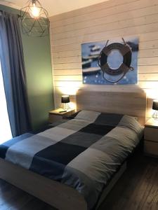 a bedroom with a bed with a nautical sign on the wall at Apartament Nad Morzem in Rowy