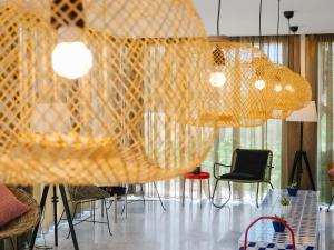 a room with chairs and a table with nets at Topazio Vibe Beach Hotel & Apartments - Adults Friendly in Albufeira
