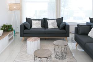 a living room with a couch and two tables at RVHotels Nieves Mar in L'Escala