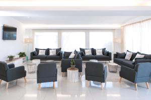 a living room with black couches and chairs at RVHotels Nieves Mar in L'Escala
