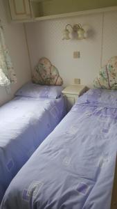 チャペル・セント・レオナルズにあるStatic caravanのベッド2台が隣同士に設置された部屋です。
