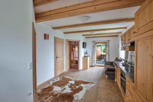 a kitchen with wooden floors and white walls at Ferienhof Schneiderweg in Laussa