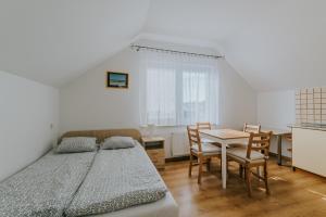 a bedroom with a bed and a table and chairs at Chatka Morska in Karwia