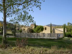 a house with a fence in a yard at Gîte Aux Tournesols in Malaucène