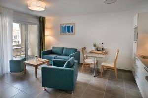 a living room with a couch and a table at Domitys La Palombine in Saint-Raphaël +12 photos