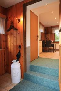 a hallway with stairs leading to a kitchen and a dining room at Ferienhaus Erzgebirge "An der Trebe" mit Kamin und Sauna in Neuhausen