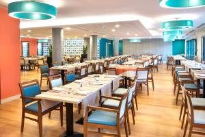 a large dining room with tables and chairs at Domitys La Palombine in Saint-Raphaël