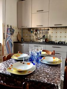 a kitchen with a table with plates and dishes on it at La casa di Marty B&B in Berceto