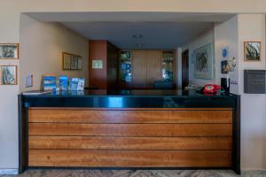 a bar with a blue counter top in a room at Corali Hotel in Kymi