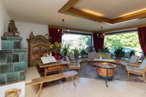 a living room filled with furniture and a fireplace at Landhotel Die Waldschänke in Kochel