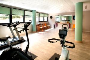 a gym with two exercise bikes and a living room at Domitys La Palombine in Saint-Raphaël +11 photos