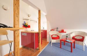 a kitchen and living room with a red refrigerator at Villa Möwenstein in Timmendorfer Strand