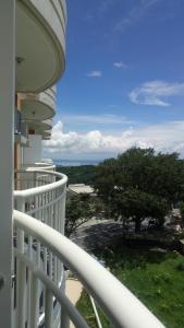 a balcony of a house with a view of the ocean at HappyNest Couple room DF in Tagaytay