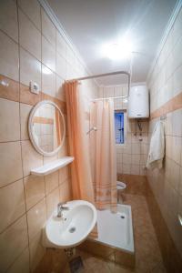a bathroom with a sink and a mirror at Šanić Apartments 518 in Lopar