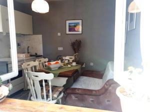 a kitchen with a table and chairs in a room at Marty Apartment in Rogoznica