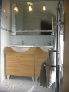 a bathroom with a sink and a mirror at Hotel Ferney République in Paris