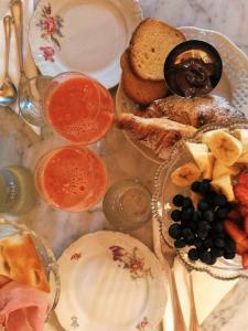 a plate of food with bread and fruit on a table at Casa Dellatorre in Alba