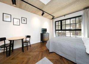 a bedroom with a bed and a table and a window at Katla Maja Apartment in Tallinn