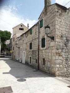an old stone building with a street light next to it at Apartment Rosse in Split +26 photos