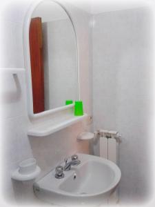 a white bathroom with a sink and a mirror at Hotel Residence Villa Teresa in Ischia