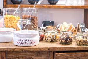 a table with jars of nuts and other foods at Hotel Villa Rina in Riva del Garda