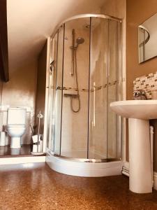a bathroom with a shower and a sink at Tresillian House in Melton Mowbray
